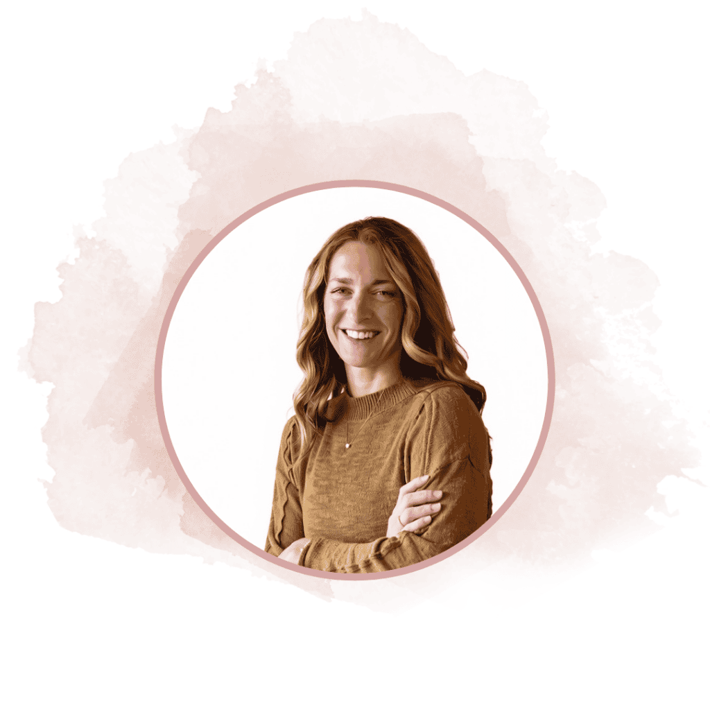 Portrait of a smiling woman with wavy blond hair in a brown knit sweater, circular pink-bordered frame on a soft pink watercolor background.