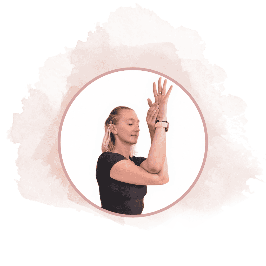 Woman in black shirt raising her arms in a gentle stretch, eyes closed, framed by a circular pink border against a watercolor backdrop.